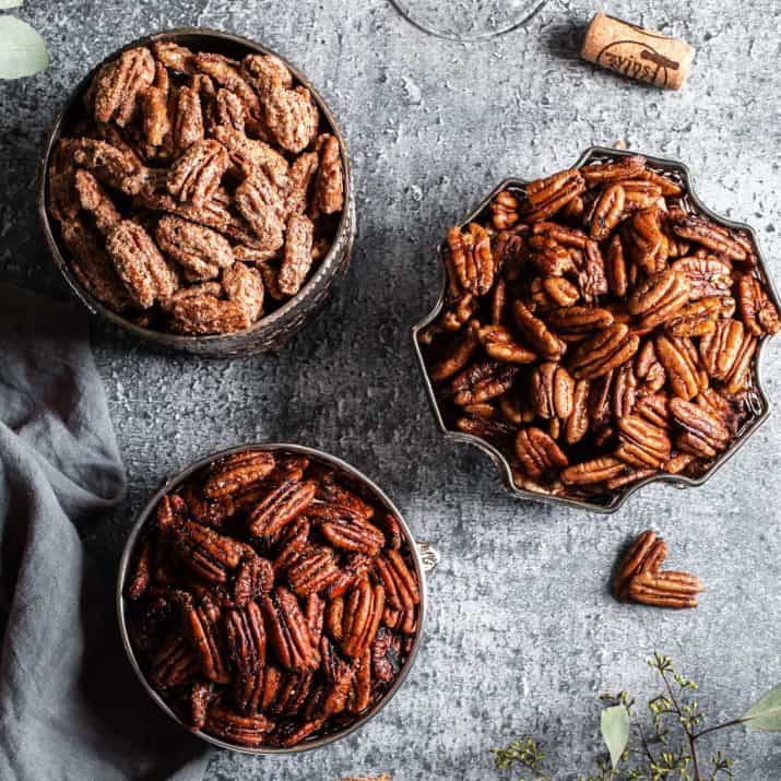 three bowls of different seasoned pecans.