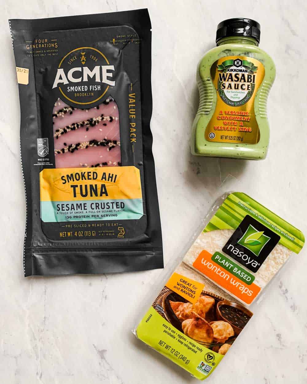tuna, wasabi, and wontons packaged ingredients on marble background.