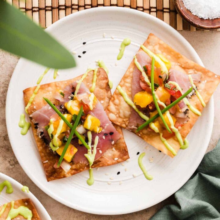 plate with smoked ahi tuna on fried wontons, with fruit salsa on top.