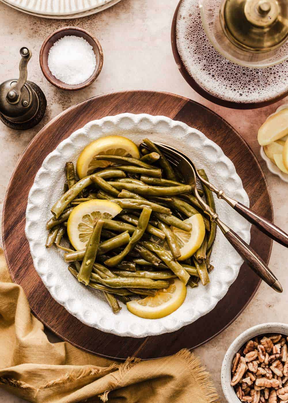 green beans with lemon slices served in white bowl on dining table.