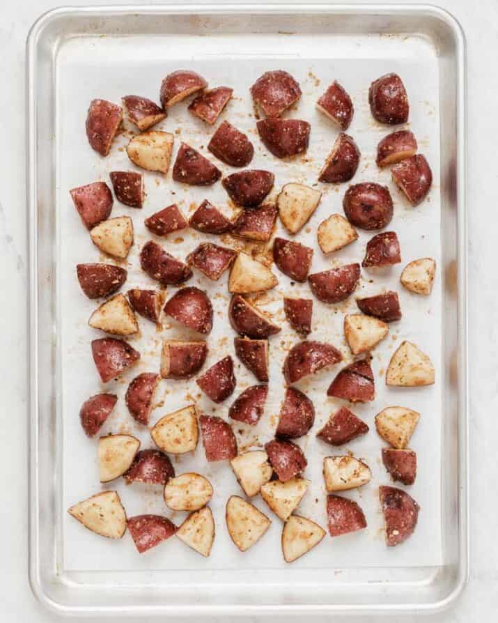 cut potatoes on sheet pan ready to roast. 